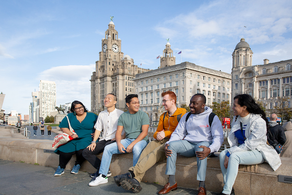 Photo showing a group of students, with the Liver Building in the background.
