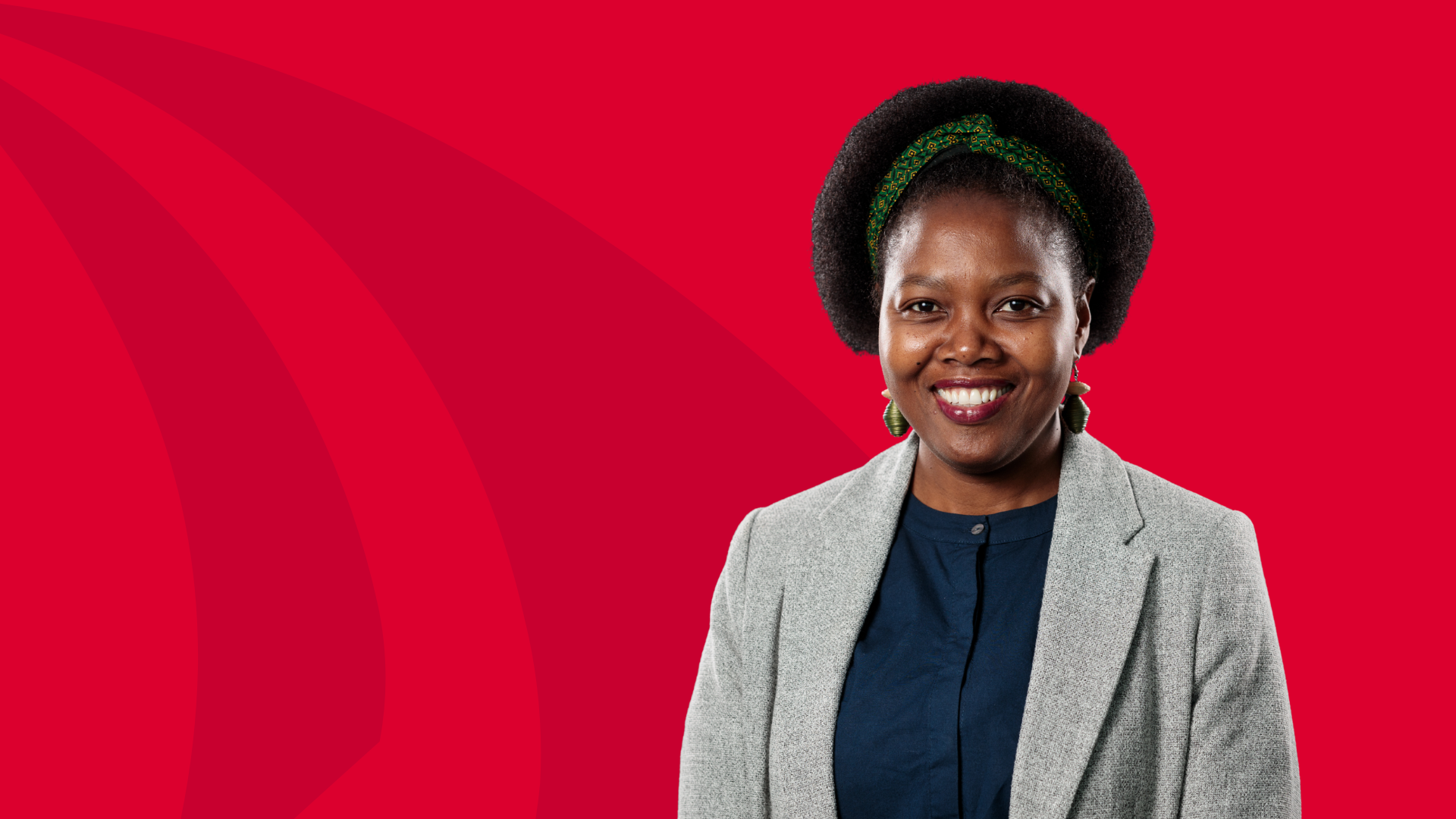 A photo of Professor Euphemia Sibanda in front of a red background.