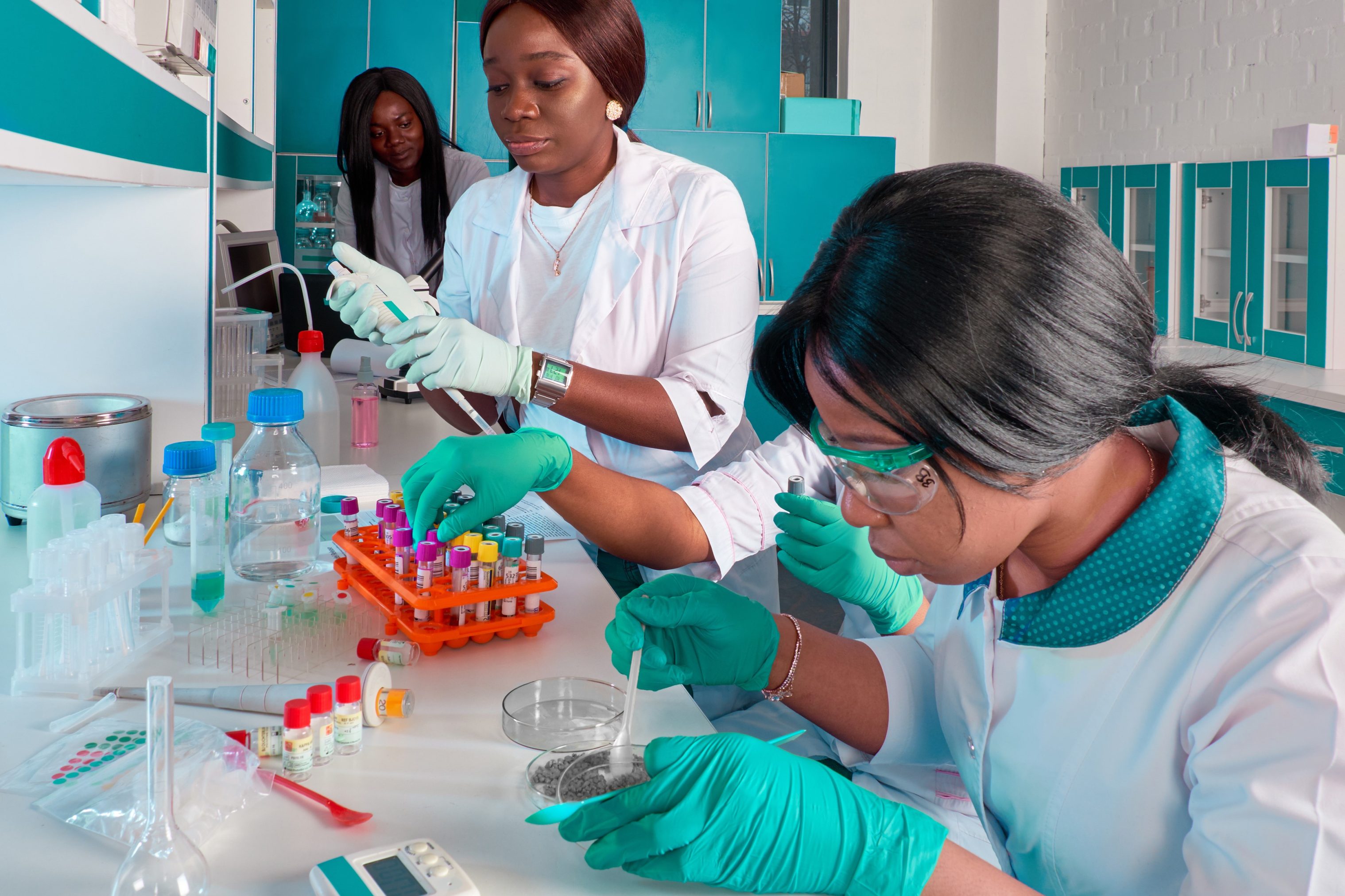 Medical students, scientists, young women working in research laboratory, medical test lab. Basic research in biology, chemistry. Quality control of various substances. Laboratory environment.