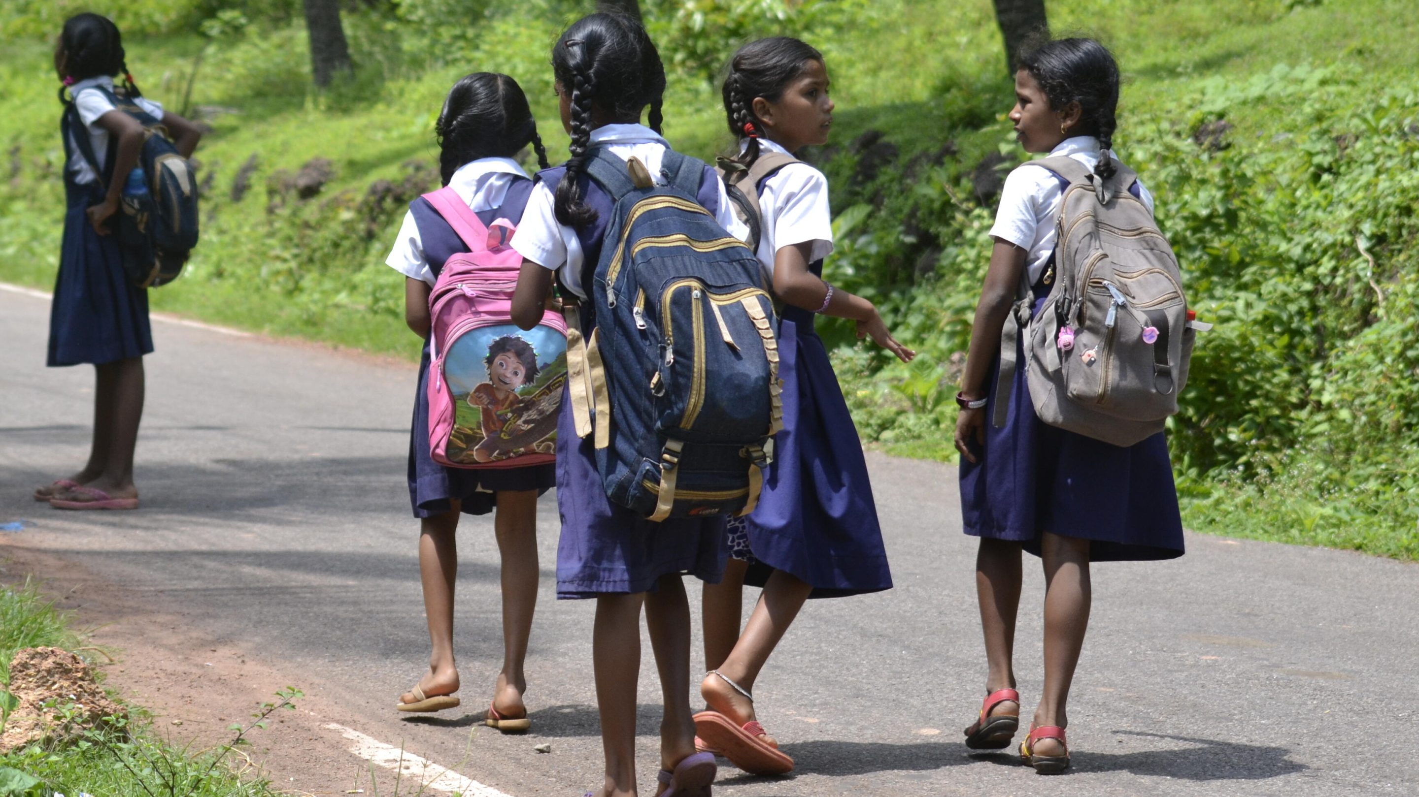 A photograph of a group of school girls walking home in Goa, India.