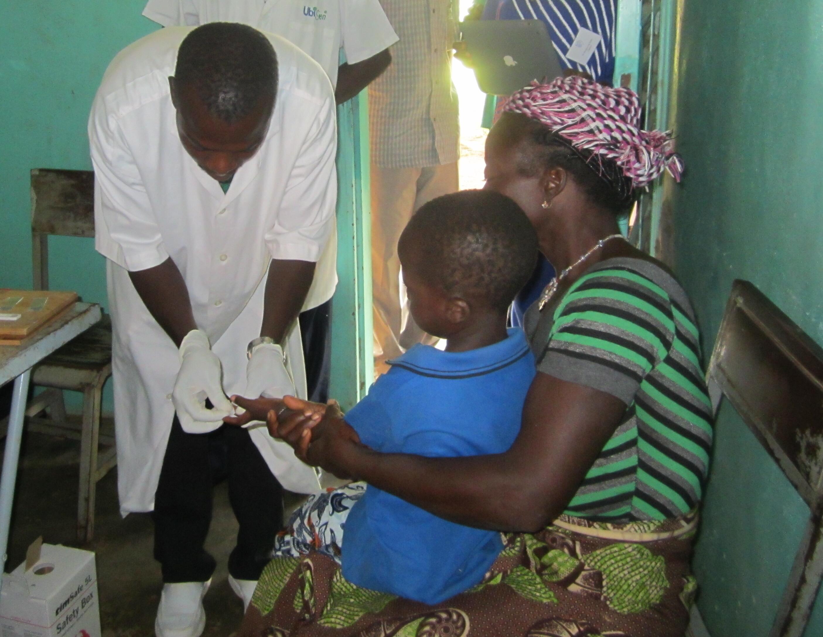 A photo taken in Burkina Faso of a mother and child visiting a doctor.