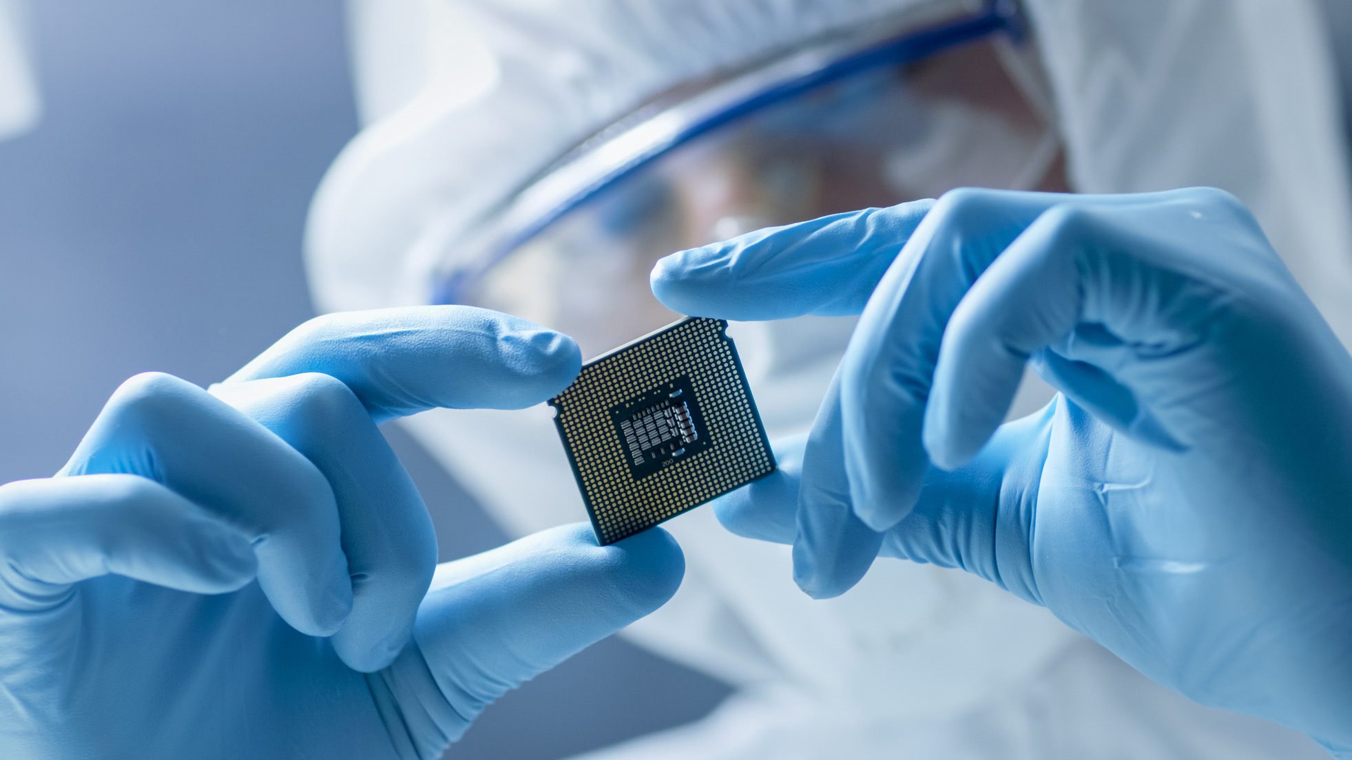 Photo of someone in a lab holding a silicon chip
