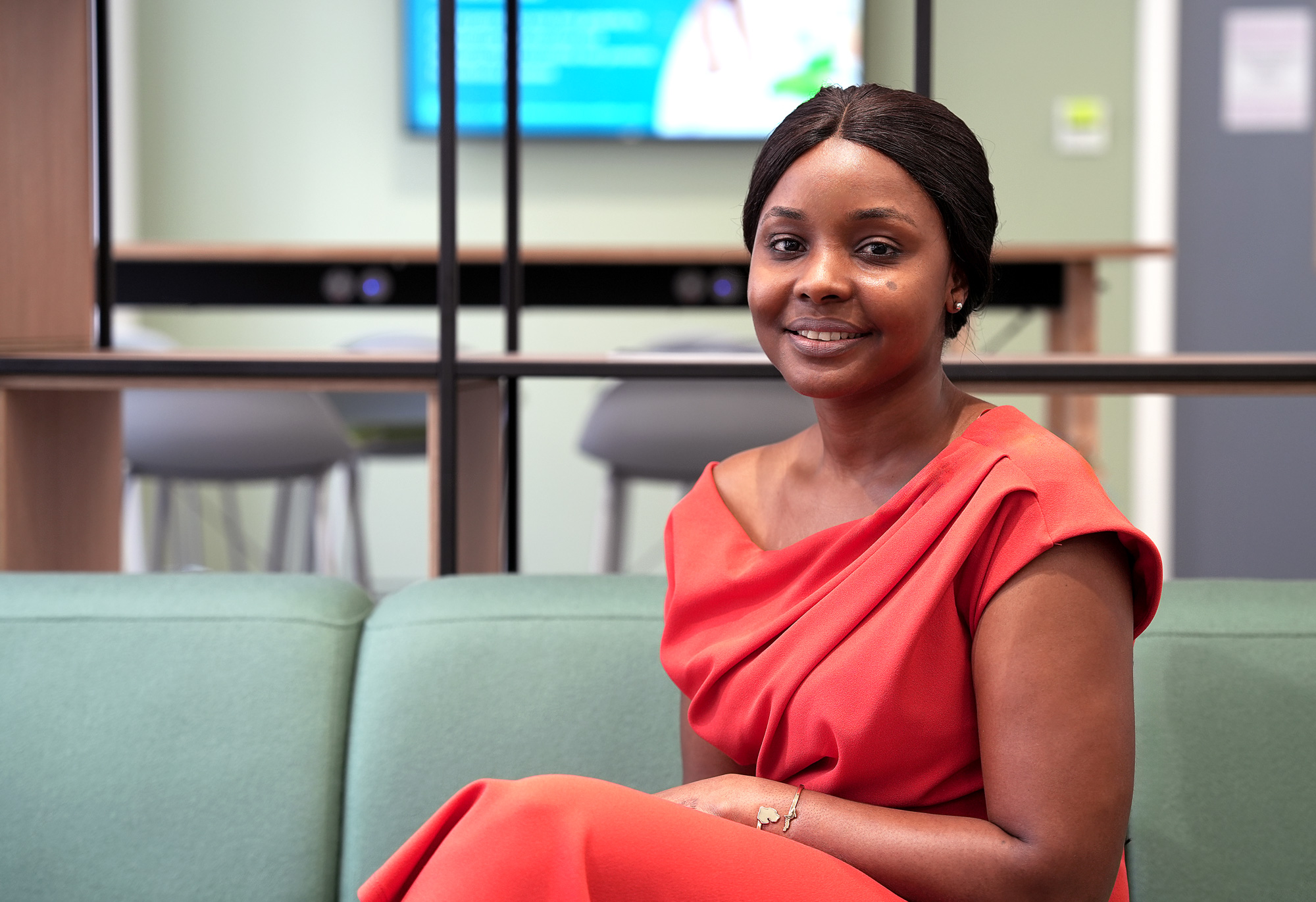 Photo of Fatoumata seated in a red dress