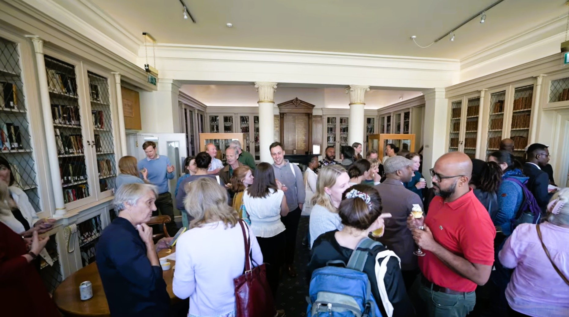 Photo of alumni and LSTM staff in the networking in the ornate library of the Liverpool Medical Institution & Conference Centre
