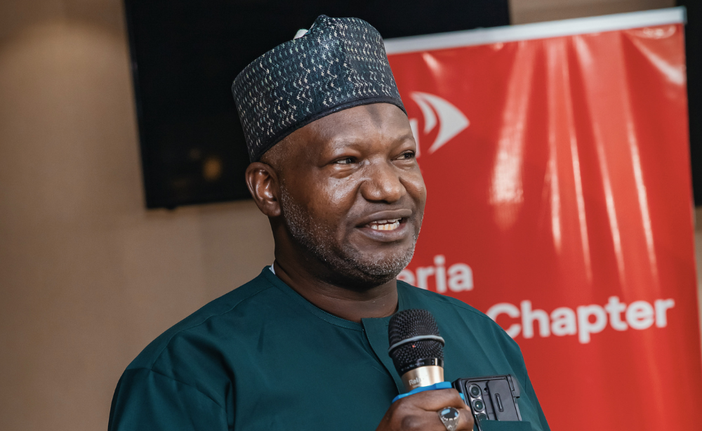 Close up headshot of Professor Ibrahim Kida speaking at the LSTM Nigeria Alumni Chapter launch event holding a microphone.